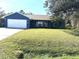 Newly painted blue house with a white garage door and well-maintained lawn at 2933 Vizza Ln, North Port, FL 34286