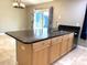 Kitchen island with granite countertop and light wood cabinets at 2933 Vizza Ln, North Port, FL 34286