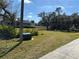 Vacant lot with green grass and trees at 2933 Vizza Ln, North Port, FL 34286