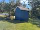 Blue shed in backyard with green grass at 2933 Vizza Ln, North Port, FL 34286