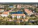 Aerial view of condo community with lake, pool, and lush landscaping at 300 San Lino Cir # 322, Venice, FL 34292