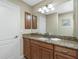 Bathroom with granite countertop, single sink, and mirror at 300 San Lino Cir # 322, Venice, FL 34292