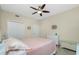 Bedroom with queen-size bed, ceiling fan, and dresser at 300 San Lino Cir # 322, Venice, FL 34292