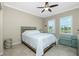 Comfortable bedroom with ceiling fan and views of the water at 300 San Lino Cir # 322, Venice, FL 34292