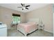 Bedroom with queen-size bed, ceiling fan, and bookcase at 300 San Lino Cir # 322, Venice, FL 34292