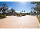 Gated entrance to community with paved brick road and landscaping at 300 San Lino Cir # 322, Venice, FL 34292