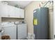 Laundry room with washer, dryer, and overhead cabinets at 300 San Lino Cir # 322, Venice, FL 34292