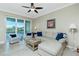 Living room with sectional sofa, coffee table, and access to screened balcony at 300 San Lino Cir # 322, Venice, FL 34292