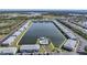 Aerial view of condo community featuring a central lake and pool at 3310 Loveland Blvd # 802, Punta Gorda, FL 33980