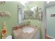 Small bathroom with granite countertop and light green walls at 3310 Loveland Blvd # 802, Punta Gorda, FL 33980