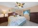 King-size bed, wood furniture, and a ceiling fan at 3310 Loveland Blvd # 802, Punta Gorda, FL 33980