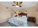 King-size bed, wood furniture, and a ceiling fan at 3310 Loveland Blvd # 802, Punta Gorda, FL 33980