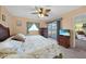 King-size bed, private balcony, and ceiling fan at 3310 Loveland Blvd # 802, Punta Gorda, FL 33980