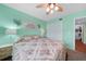 Spacious bedroom with floral bedding and ceiling fan at 3310 Loveland Blvd # 802, Punta Gorda, FL 33980