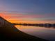 Stunning sunset over a tranquil lake with waterfront community at 3310 Loveland Blvd # 802, Punta Gorda, FL 33980