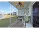 Screened lanai overlooking a lake with wicker furniture at 3310 Loveland Blvd # 802, Punta Gorda, FL 33980