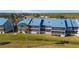 Aerial view of condo building, showcasing blue roofs and screened balconies at 4410 Warren Ave # 403, Port Charlotte, FL 33953