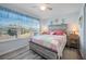 Bedroom with a queen bed, ceiling fan, and water views at 4410 Warren Ave # 403, Port Charlotte, FL 33953