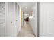 Long hallway with white doors and storage at 4410 Warren Ave # 403, Port Charlotte, FL 33953