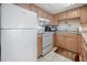 White appliances and light wood cabinets in this galley kitchen at 4410 Warren Ave # 403, Port Charlotte, FL 33953