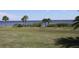 Wooden pier extending over calm water, palm trees in foreground at 4410 Warren Ave # 403, Port Charlotte, FL 33953