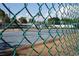 View of tennis court through chain-link fence at 4410 Warren Ave # 403, Port Charlotte, FL 33953