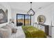 Guest bedroom with green velvet bedding and sliding glass doors at 48 Master Dr, Placida, FL 33946