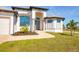 Front entrance with columns and a walkway leading to the house at 48 Master Dr, Placida, FL 33946