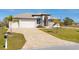 Landscaped property featuring a paved driveway and a two-car garage at 48 Master Dr, Placida, FL 33946