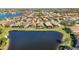 Bird's-eye view of upscale community, showcasing lakefront homes and landscaping at 484 Casalino Dr, Nokomis, FL 34275