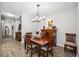 Spacious dining area with hardwood floors and a large chandelier at 484 Casalino Dr, Nokomis, FL 34275