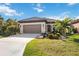 One-story home with attached garage and landscaped yard at 484 Casalino Dr, Nokomis, FL 34275