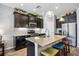 Spacious kitchen featuring granite island, stainless steel appliances, and dark cabinetry at 484 Casalino Dr, Nokomis, FL 34275