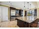 Modern kitchen with granite countertops, stainless steel appliances, and dark wood cabinetry at 484 Casalino Dr, Nokomis, FL 34275