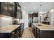 Granite countertops and dark wood cabinets highlight this modern kitchen at 484 Casalino Dr, Nokomis, FL 34275