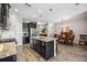 Modern kitchen with island and dining area with wood table and chairs at 484 Casalino Dr, Nokomis, FL 34275