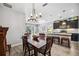 Open concept kitchen and dining area with dark cabinets and granite counters at 484 Casalino Dr, Nokomis, FL 34275