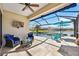 Covered patio overlooking the pool and lake at 484 Casalino Dr, Nokomis, FL 34275