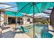 Inviting pool with patio furniture and umbrellas at 484 Casalino Dr, Nokomis, FL 34275