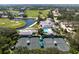 Aerial view of community with clubhouse, pool, tennis courts, and golf course at 523 Fallbrook Dr, Venice, FL 34292