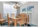 Formal dining room featuring a wood table and decorative artwork at 523 Fallbrook Dr, Venice, FL 34292