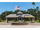 Gated entrance to community with fountain and flag at 523 Fallbrook Dr, Venice, FL 34292