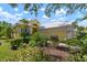 Attractive yellow house with lush landscaping and a two-car garage at 523 Fallbrook Dr, Venice, FL 34292