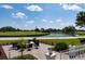 Enjoy this fire pit area with chairs and scenic golf course views at 523 Fallbrook Dr, Venice, FL 34292