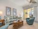 Comfortable living room with a sofa, armchairs, and a coastal vibe at 523 Fallbrook Dr, Venice, FL 34292