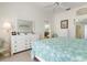 Main bedroom with king bed and white dresser at 523 Fallbrook Dr, Venice, FL 34292