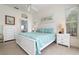 Main bedroom with king bed and white dresser at 523 Fallbrook Dr, Venice, FL 34292