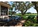 Outdoor patio furniture with view of lush landscaping and golf course at 523 Fallbrook Dr, Venice, FL 34292