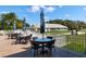 Outdoor patio furniture with glass-top tables, overlooking a golf course at 523 Fallbrook Dr, Venice, FL 34292