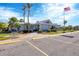 Side view of community clubhouse with parking and landscaping at 545 Foxwood Blvd # 23, Englewood, FL 34223